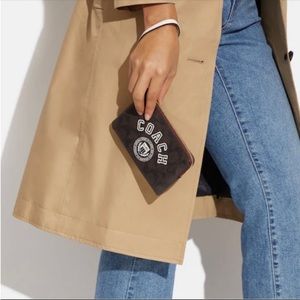 NWT COACH Corner Zip Wristlet In Signature Canvas With Varsity Motif - Brown